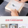 Hands are placing a wooden box containing a delicate item wrapped in bubble wrap onto a textured surface.