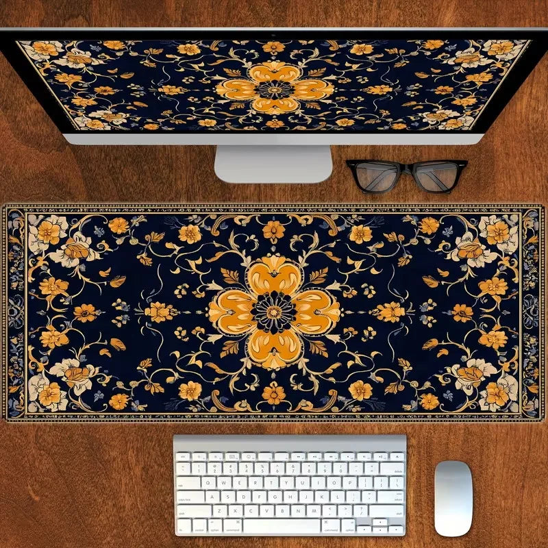 A vintage Persian rug design mouse pad featuring gold and yellow floral patterns, placed next to a computer monitor and keybo