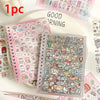 A pink spiral notebook filled with cute cartoon stickers and a clear plastic sheet of similar stickers on a white surface.
