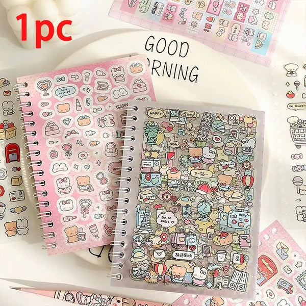 A pink spiral notebook filled with cute cartoon stickers and a clear plastic sheet of similar stickers on a white surface.