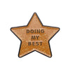 A gold-colored star enamel pin with the text DOING MY BEST engraved on it.