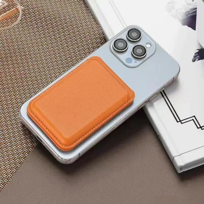 A light gray magnetic leather wallet with an orange stand case resting on a brown surface.