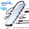 A silver multi-port 8-in-2 USB and Type-C hub featuring multiple ports including USB Type C, USB 3.0, and SD card reader.