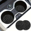 A set of two non-slip leather car cup holder coasters with leopard print designs.