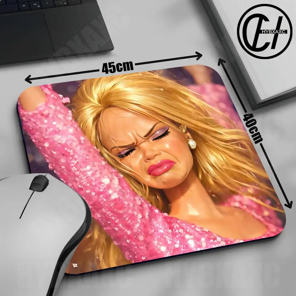 A pink glitter doll face mouse pad featuring a blonde woman and a black gaming mouse.