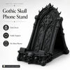 A black Gothic skull phone stand with intricate carvings and a decorative frame.