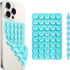 A white smartphone case and a blue silicone suction cup phone mount with multiple circular cups.