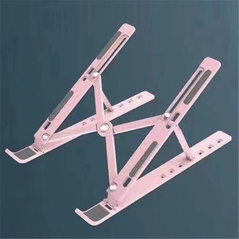 A pink foldable adjustable laptop stand with an ergonomic design shown from above.