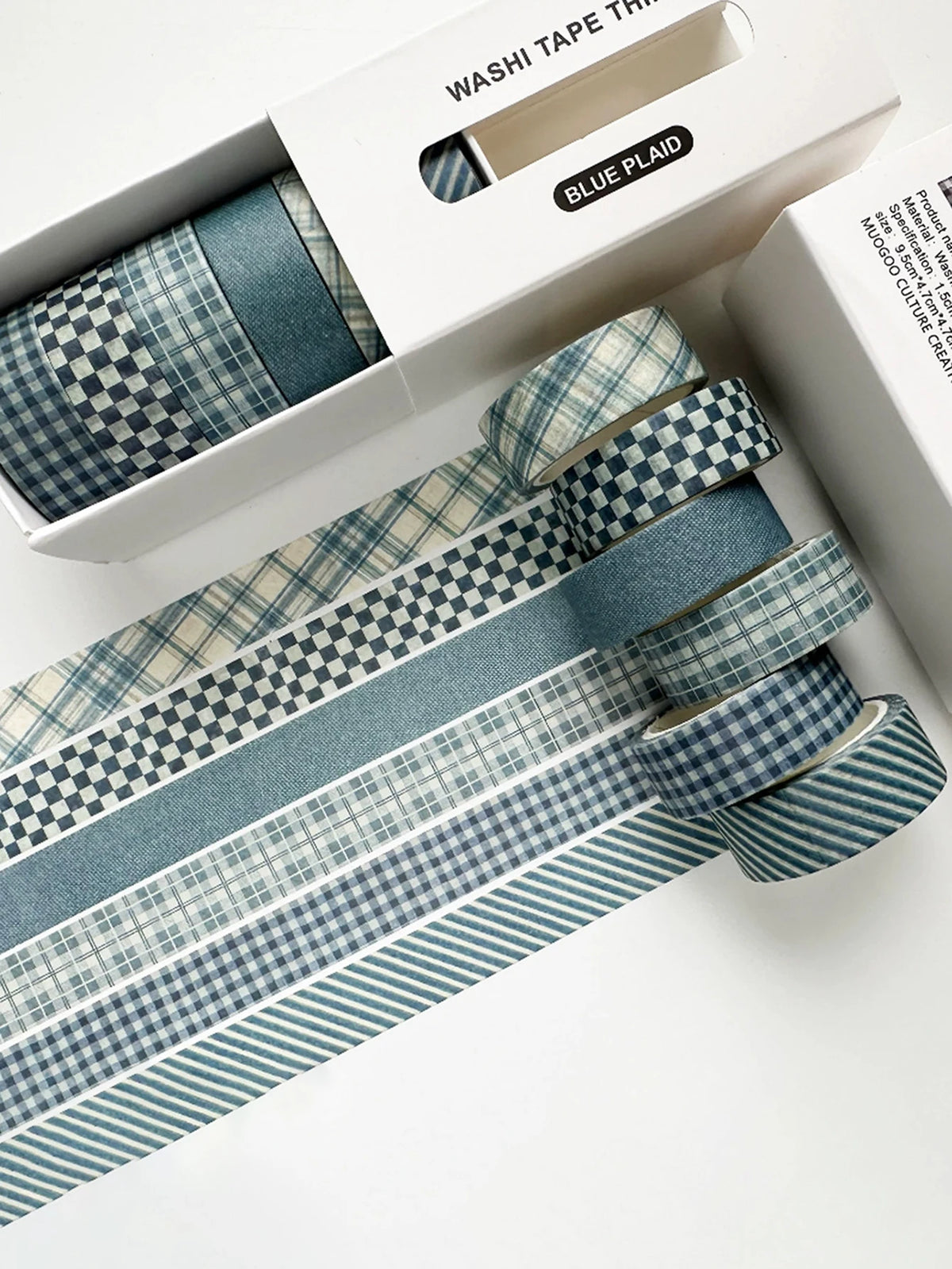 A set of blue plaid washi tape rolls featuring grid and polka dot patterns displayed in a white box.