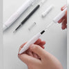 A hand holds a white gel pen with black ink and a spiral refill, demonstrating the smooth writing experience.
