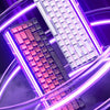 A close-up of a magnetic switch mechanical keyboard with purple and pink accents illuminated by bright neon light rings.