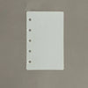 A white divider page with punched holes for loose-leaf planners.