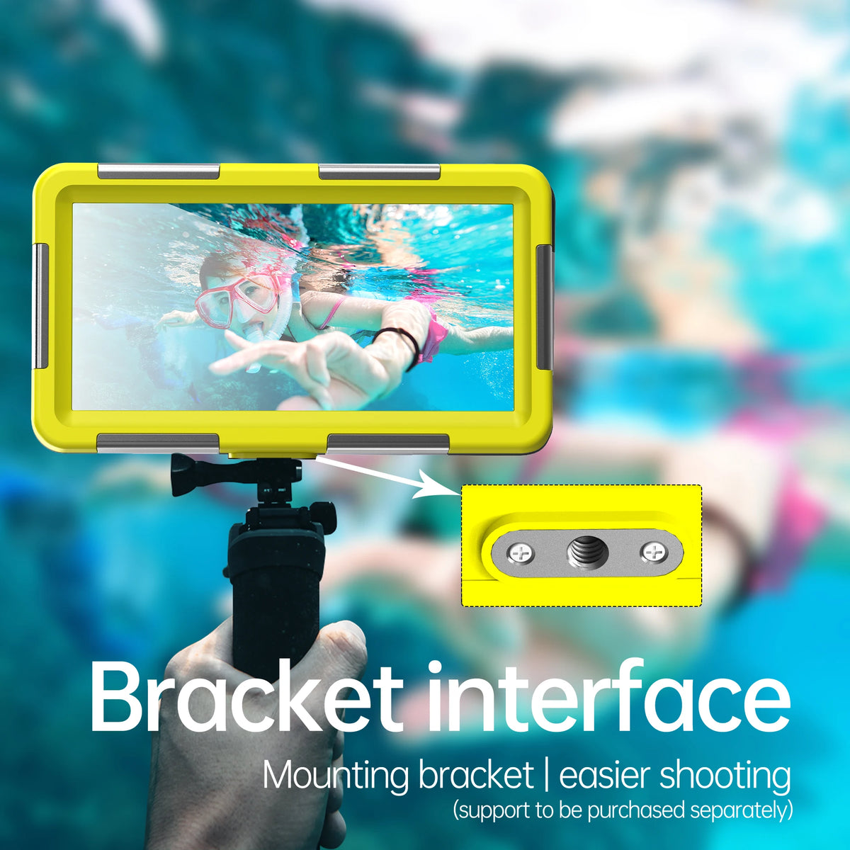 A hand holds a yellow mounting bracket interface attached to a camera, with an underwater photo displayed on the screen.