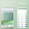 A set of hand-held painting and journaling pens in various shades of green, packaged for art and doodling.