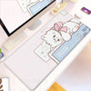 A pink mousepad featuring a white cartoon cat character for a gaming desk.