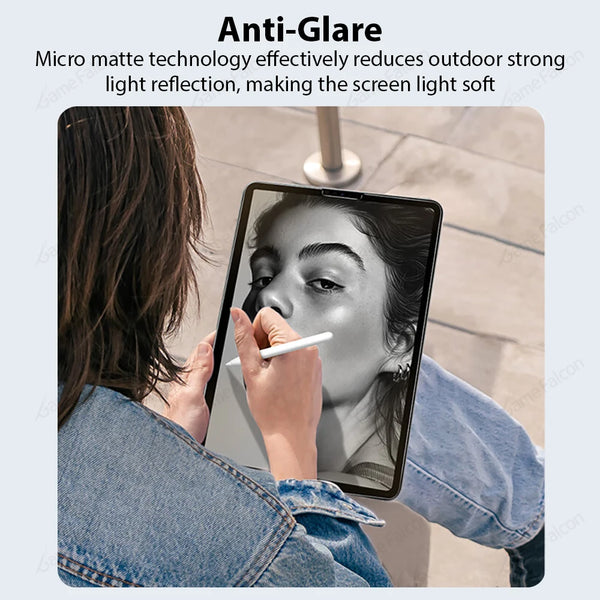 A person is using a tablet with an anti-glare screen protector, showing the soft light reflection on the screen.