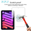 A hand holds a hammer near a tablet screen demonstrating the scratch proof feature of a tempered glass screen protector.