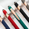A collection of black and gold retractable stylus and ballpoint pens arranged diagonally on a white surface.