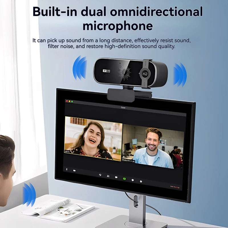 A black 4K auto-focus webcam with a built-in dual omnidirectional microphone is mounted on a computer monitor.