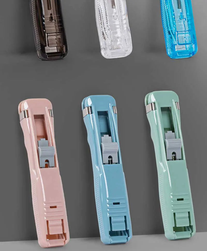 A collection of mini reusable hand clamp staplers in pink, light blue, and mint green colors.