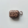 A clear silicone case with a leopard print design for an earphone cover, featuring a brown and black pattern.