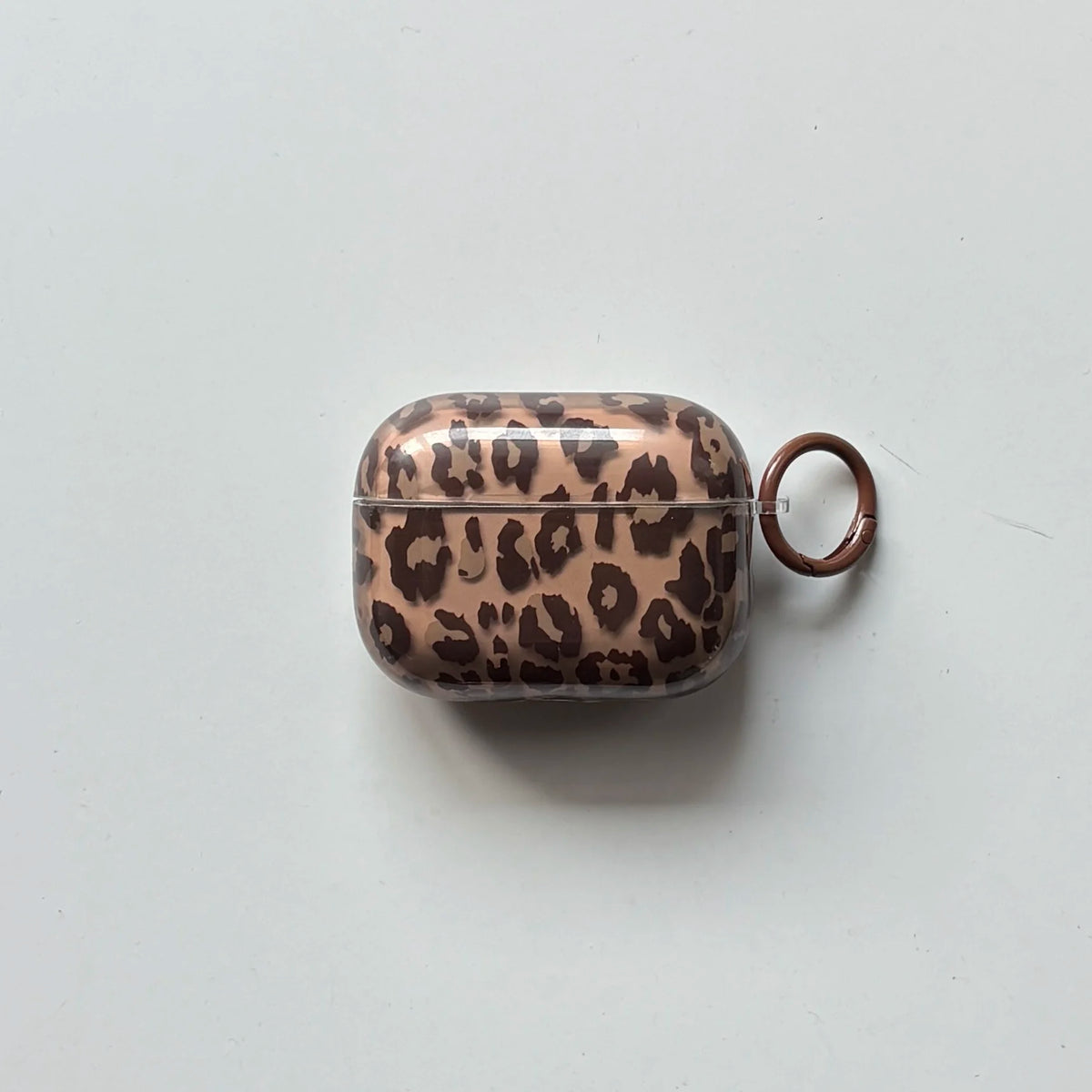 A clear silicone case with a leopard print design for an earphone cover, featuring a brown and black pattern.