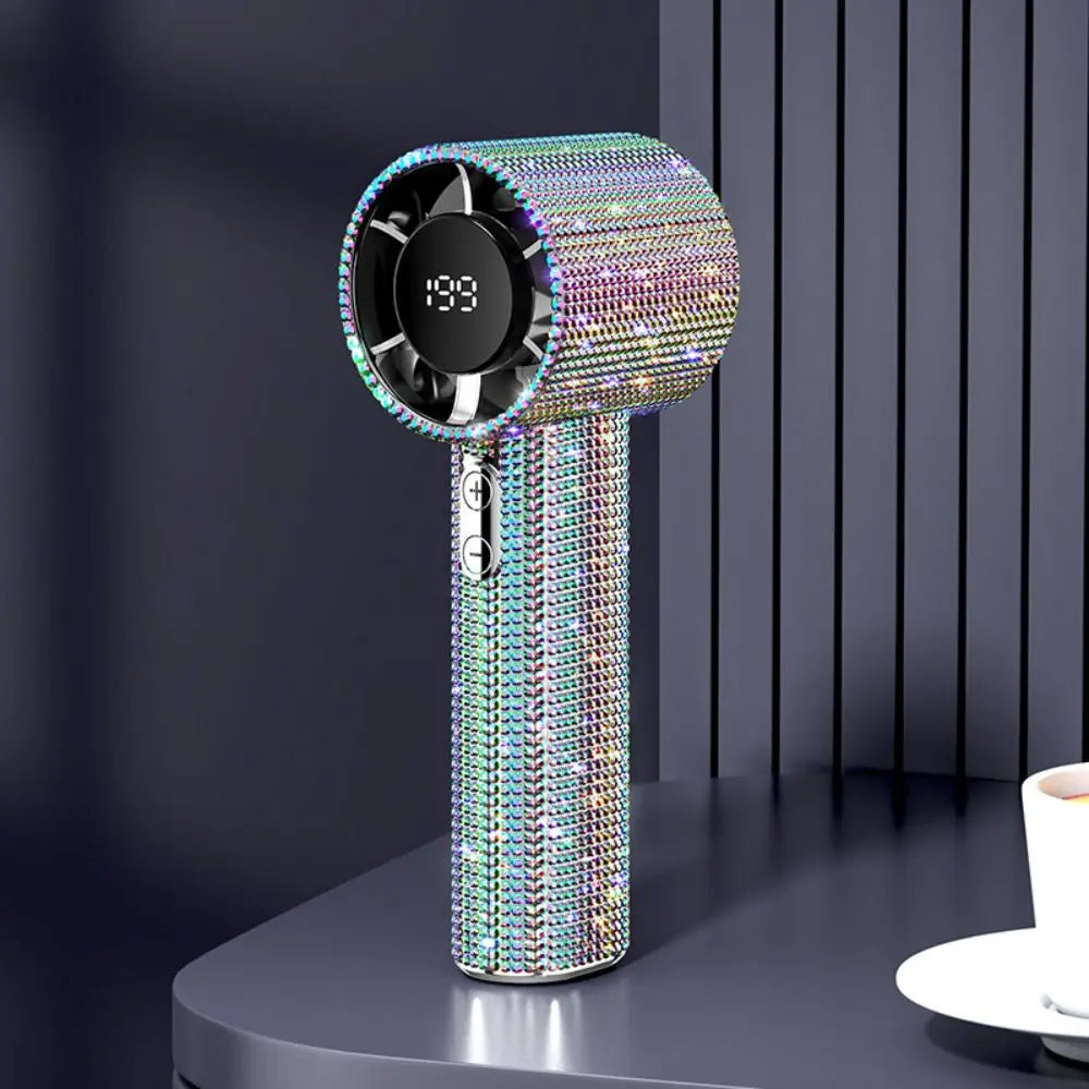 A vertical mini portable LED turbine fan with a shimmering iridescent finish, displayed on a dark surface.