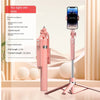 A pink 360 degree rotation selfie stick with a smartphone attached, shown next to its instruction manual.