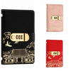 A black personal finance budget binder with a gold lock and decorative Japanese-style pattern.