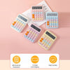 A collection of pink and blue mechanical 12-digit calculators with LCD displays arranged on a light pink background.