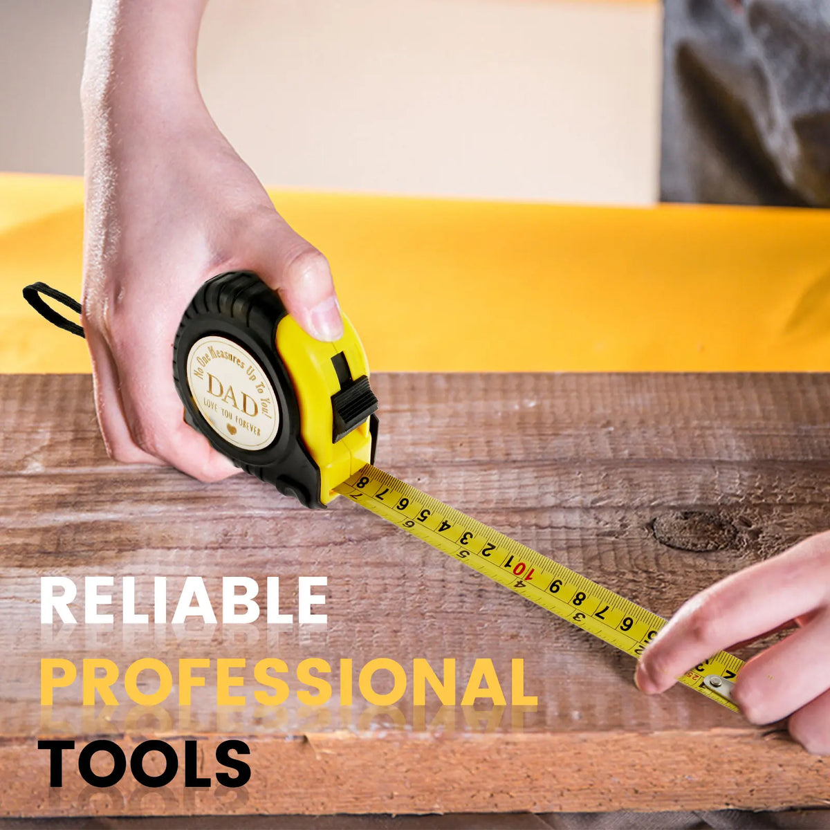 A hand holds a yellow measuring tape across a wooden surface, demonstrating reliable professional tools.