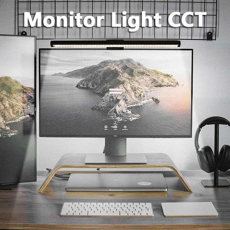 A modern monitor light bar is mounted above a computer monitor, illuminating the screen with soft light.