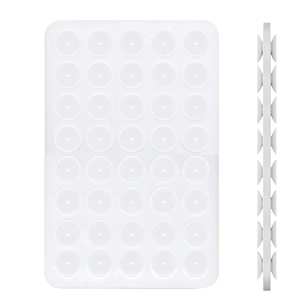 A white double-sided silicone phone mount grip with multiple circular holes.