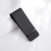 A black leather money clip with a card holder resting on a white surface.