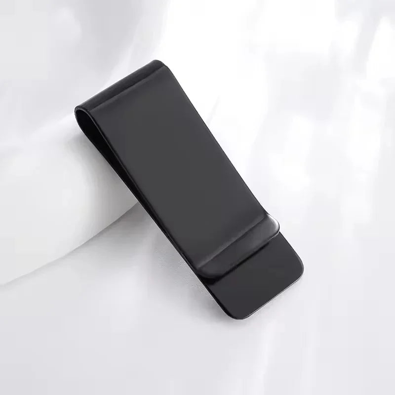 A black leather money clip with a card holder resting on a white surface.