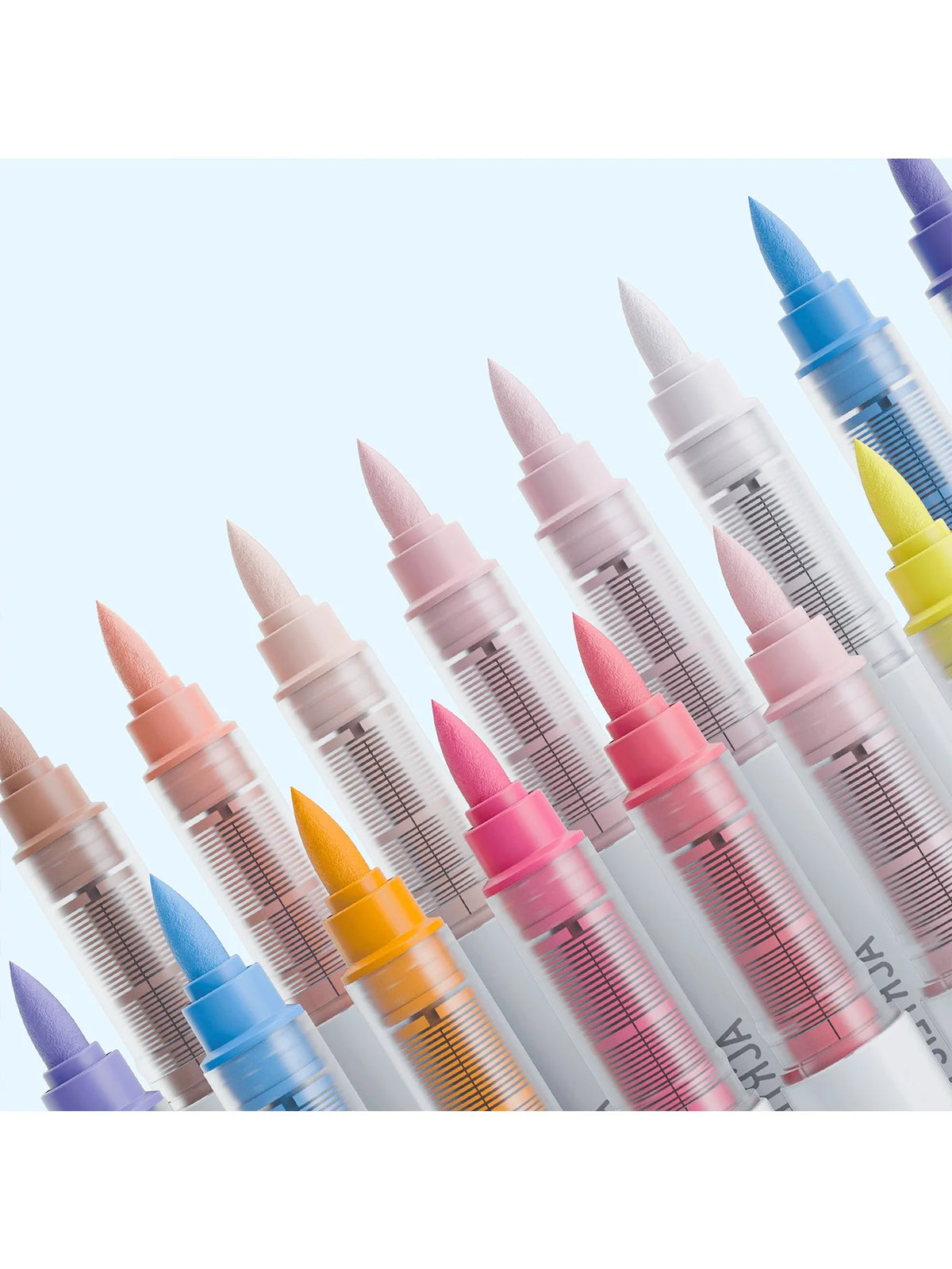 A collection of soft acrylic paint markers in various shades of pink, purple, blue, and yellow, shown in a row.