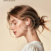 A woman is shown wearing a white earbud, demonstrating the short ear shape of the product.