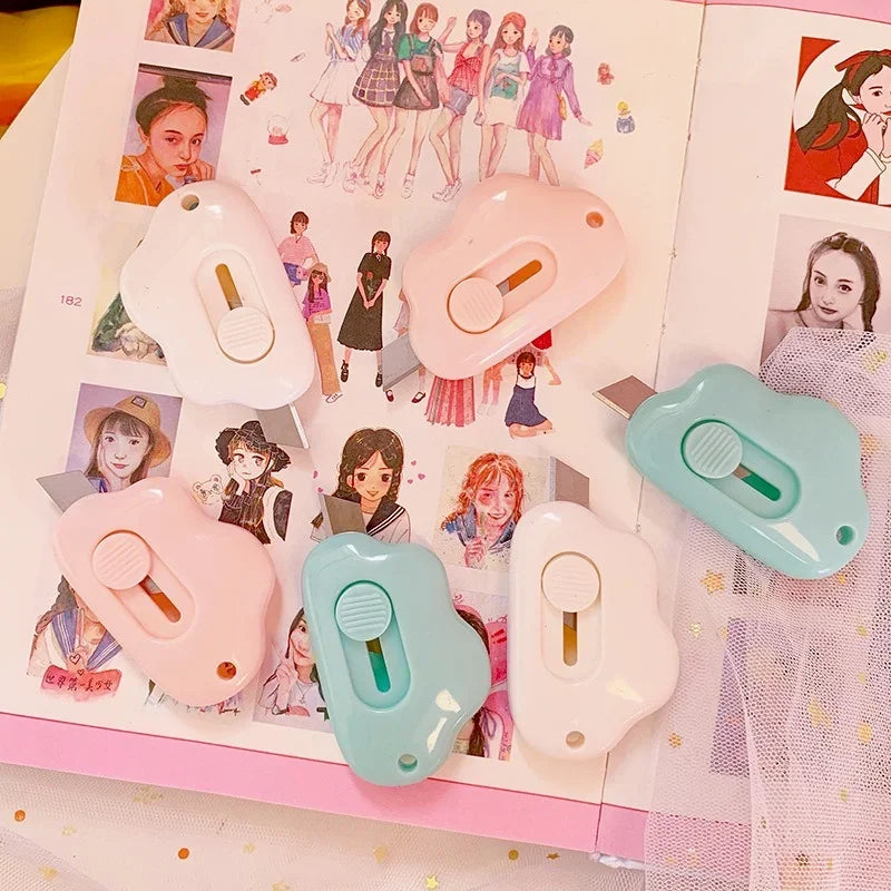 A collection of pink and teal cat paw mini cutters for mail and crafts displayed on a white background.