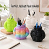 Colorful puffer jacket pen holder with various pens and pencils organized on a desk.