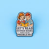 An enamel lapel pin featuring two children reading a book with the text Let's Read Banned Books and Cause Problems