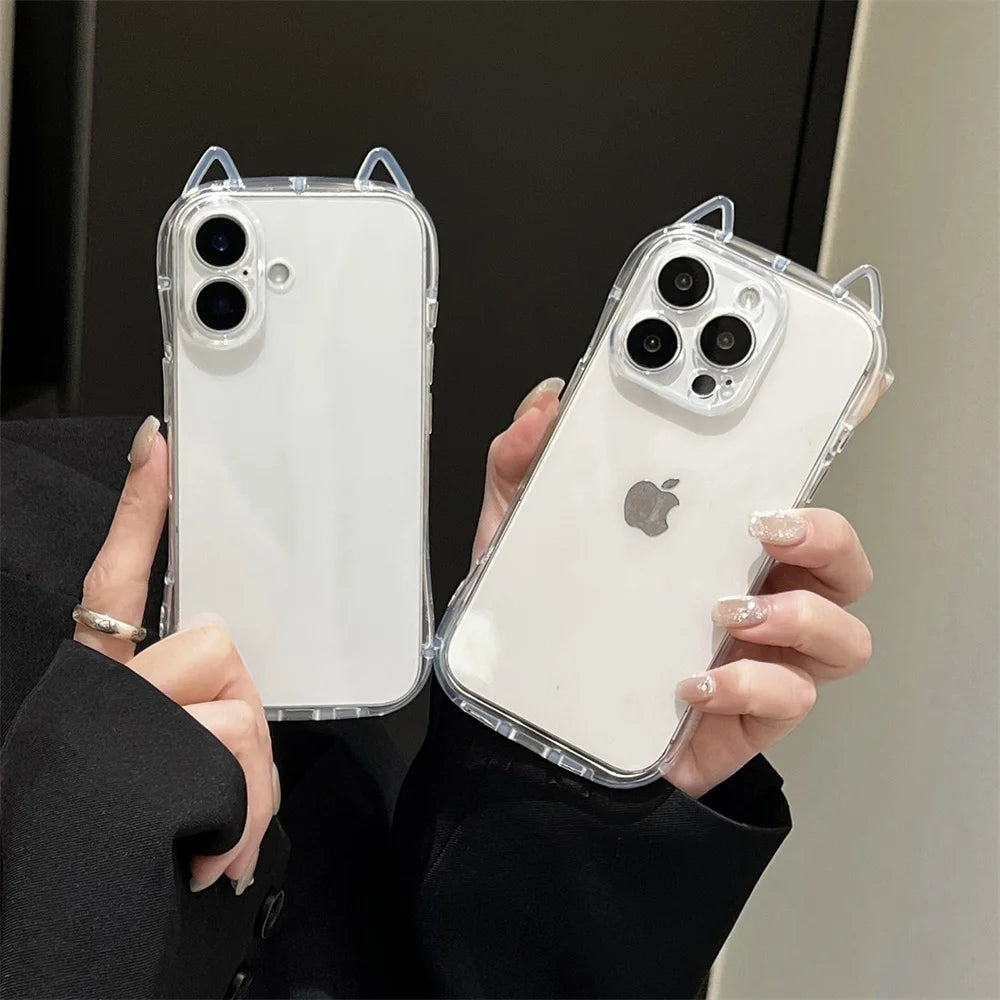 A person holds a white iPhone with a clear case featuring 3D cat ears for shockproof protection.