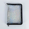 A black A5 sticker organizer binder with clear storage pockets filled with star-shaped stickers.