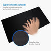 Black mouse pad with a circular anti-slip rubber base and a hand interacting with the surface.