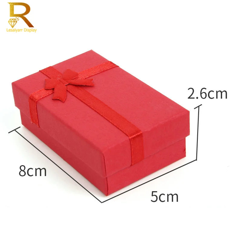 A red jewelry gift box with a ribbon, measuring 8cm by 5cm and 2.6cm high.