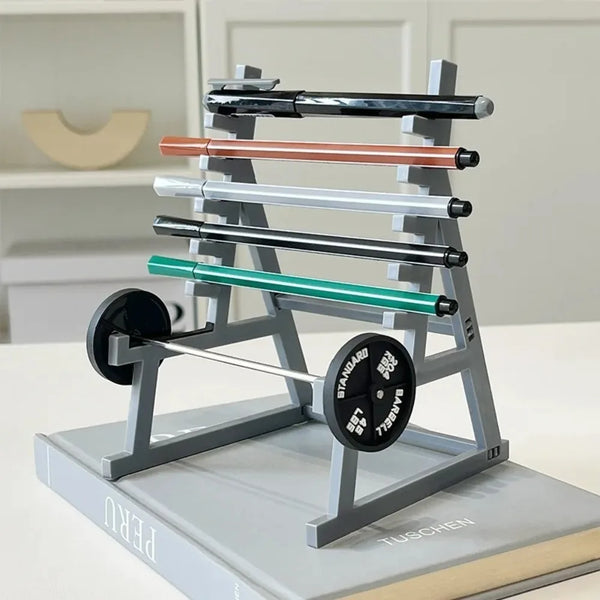 A gray barbell rack organizer holds several black and copper-colored pen holders on a desk.