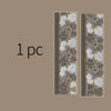 Vertical strip of decorative silver stamping lace tape featuring floral patterns on a beige background.
