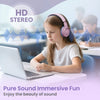A young girl is wearing pink headphones while using a laptop in a classroom setting.