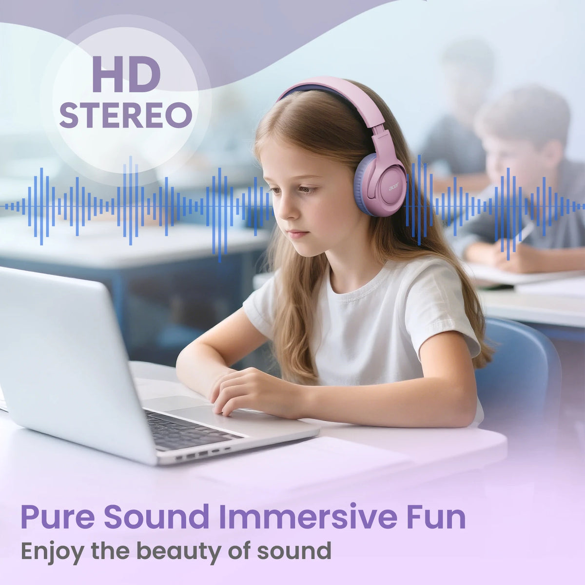 A young girl is wearing pink headphones while using a laptop in a classroom setting.