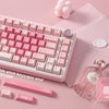 A pink mechanical keyboard with extra dove-theme dye shot keycaps and related accessories is displayed on a pink background.