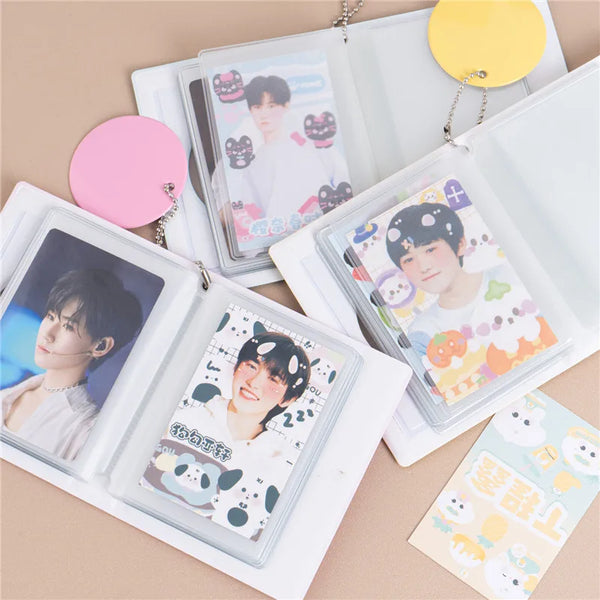 A clear binder holds various photo cards and a yellow circular tag for Kpop albums